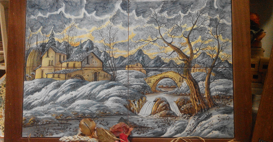 Paesaggio invernale maiolicato su piastre.